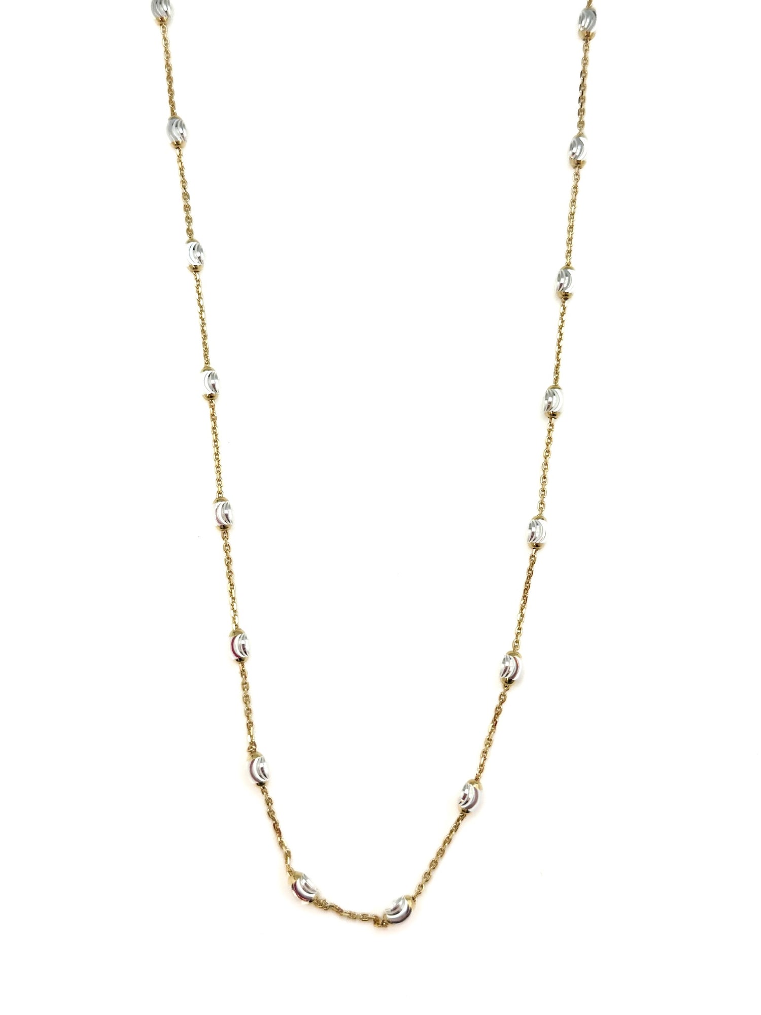 Gold chain necklace with small silver beads on a white background