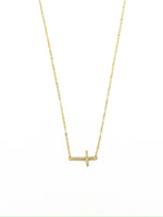 Gold necklace with a small cross pendant on a white background
