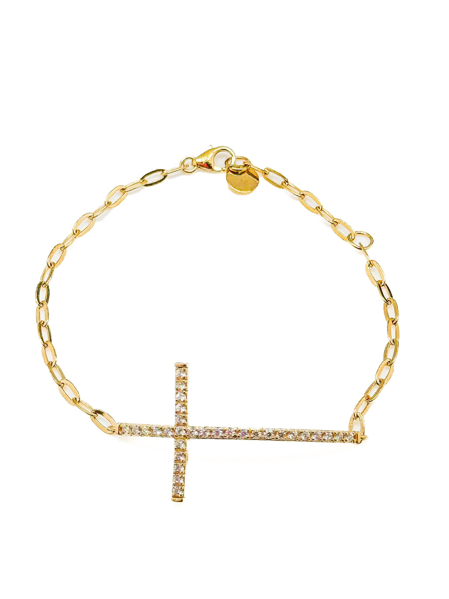 Gold bracelet with a cross charm on a white background
