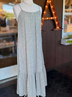 Olive green and white petite floral maxi dress with spaghetti straps, gathered neckline and flowing ruffle hem at Ardor Boutique.