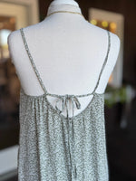 Close-up of olive green floral maxi dress showing the open back, spaghetti straps and adjustable tie at Ardor Boutique.