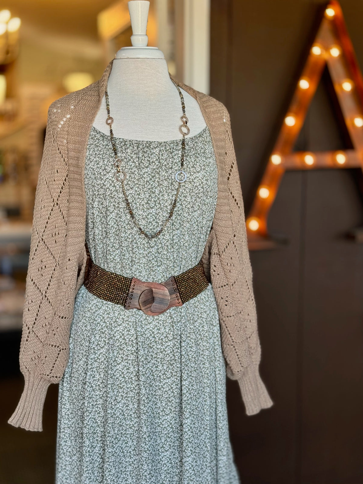 Brown open-knit cardigan with a relaxed open front, diamond knit pattern and wide ribbed cuffs at Ardor Boutique.