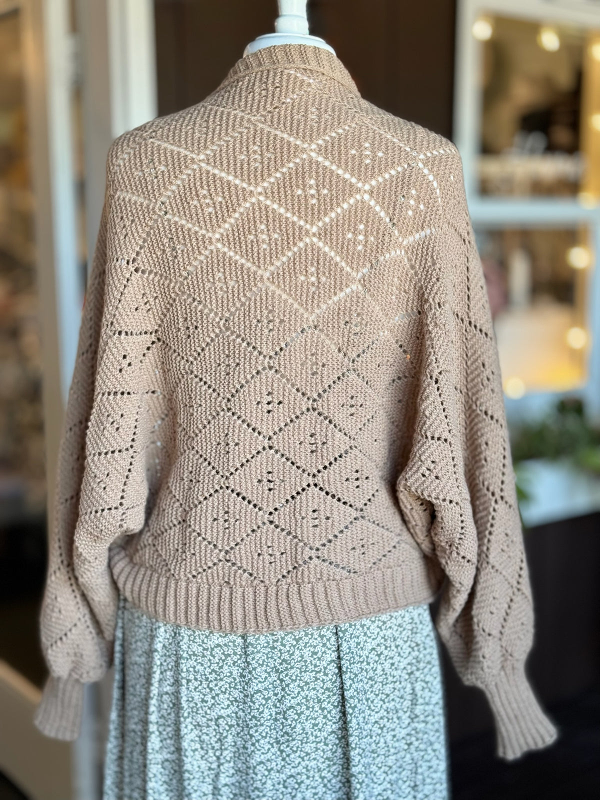 Back view of brown open-knit cardigan featuring a textured diamond pattern, relaxed sleeves and ribbed hem at Ardor Boutique.
Updated SEO