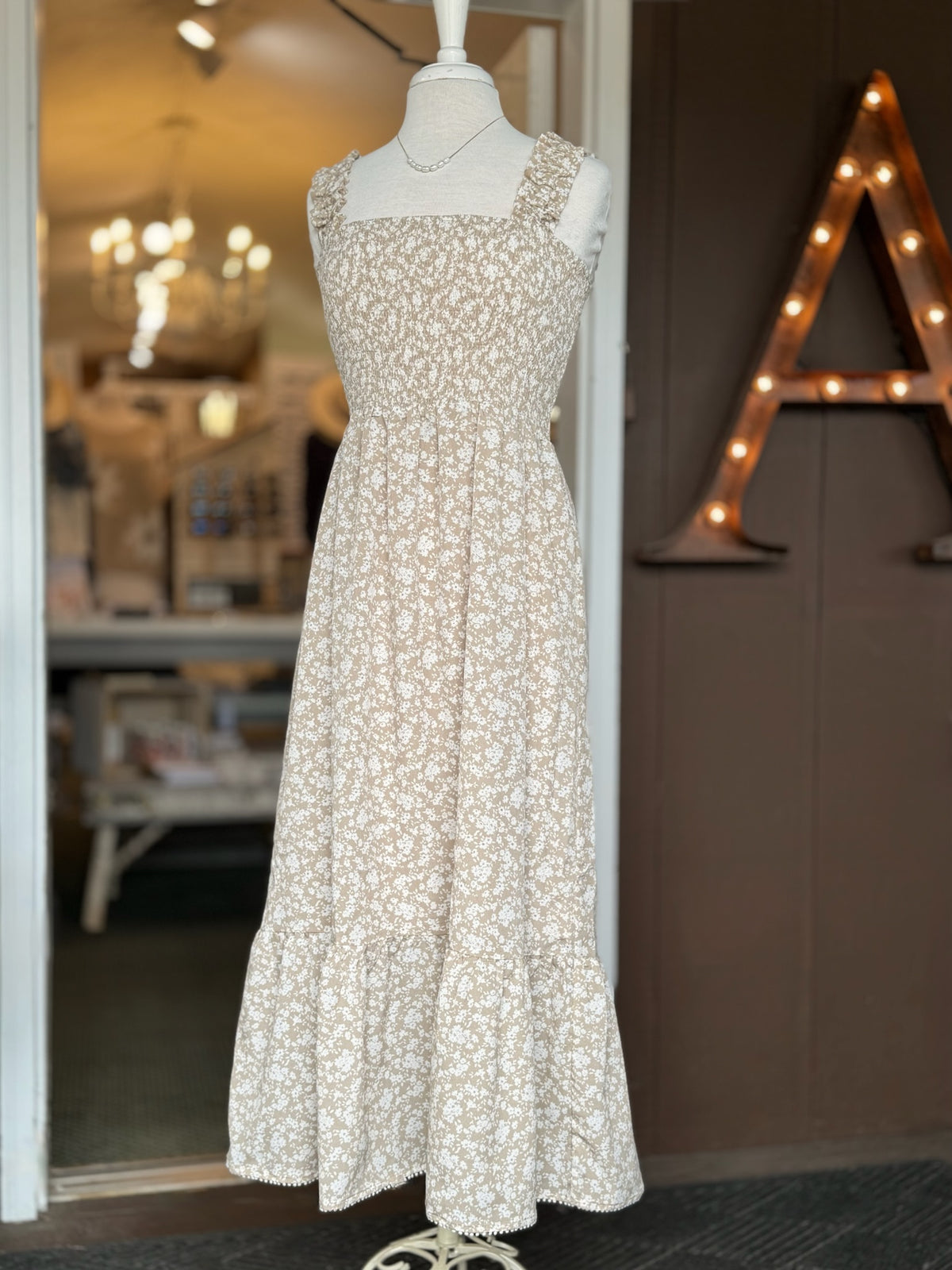 Beige floral maxi dress with a smocked bodice, square neckline, ruffle straps and a flowing skirt at Ardor Boutique.