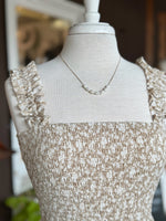 Gold Necklace with delicate freshwater pearl accents displayed on a neutral mannequin at Ardor Boutique.
