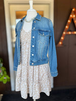 Beige and white floral dress layered with a medium wash denim jacket for an easy transitional outfit at Ardor Boutique.