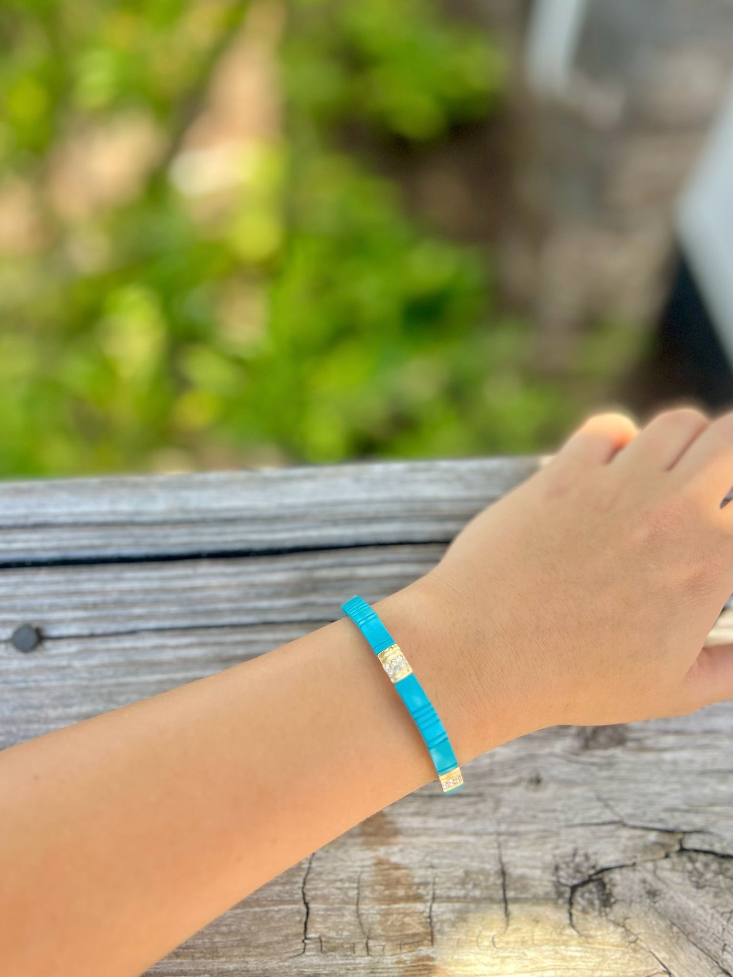 Mila Stretch Bracelet in turquoise blue with gold accents on models wrist at Ardor Boutique.