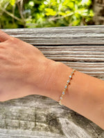 Hand wearing a bracelet with a natural background