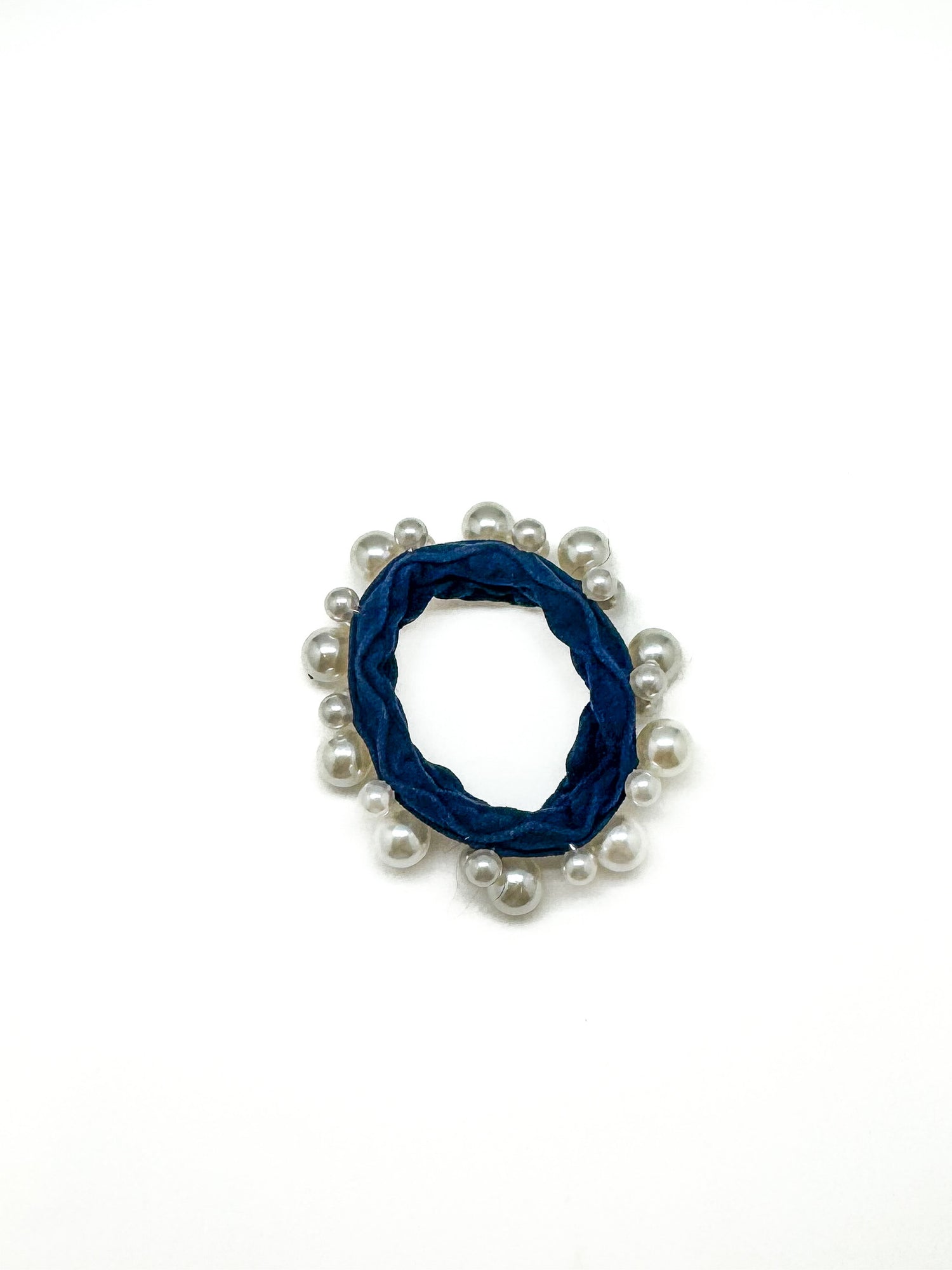 Blue scrunchie with white beads on a white background