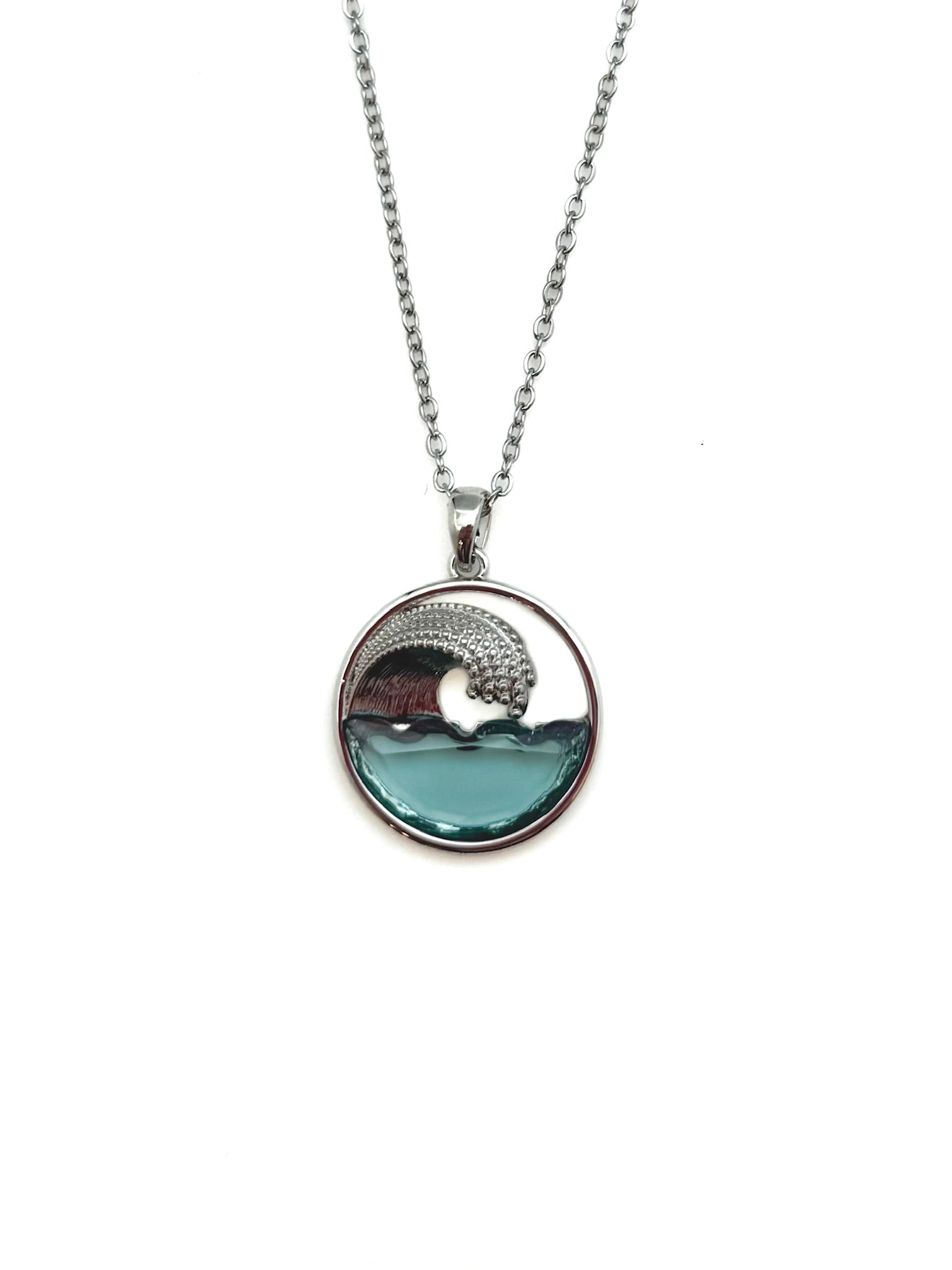 Necklace with a circular pendant featuring an ocean wave design on a white background