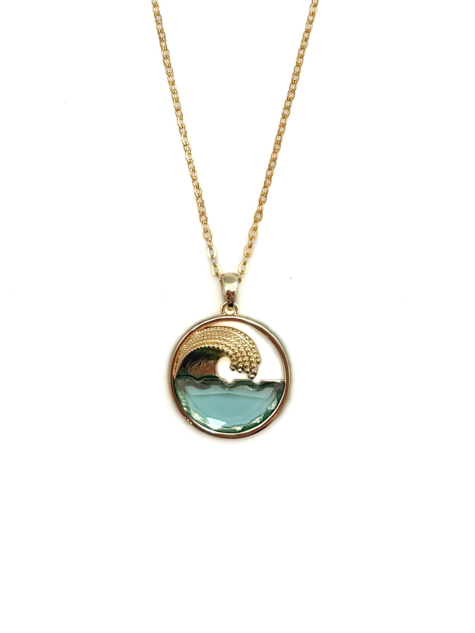 Gold necklace with a blue pendant on a white background
