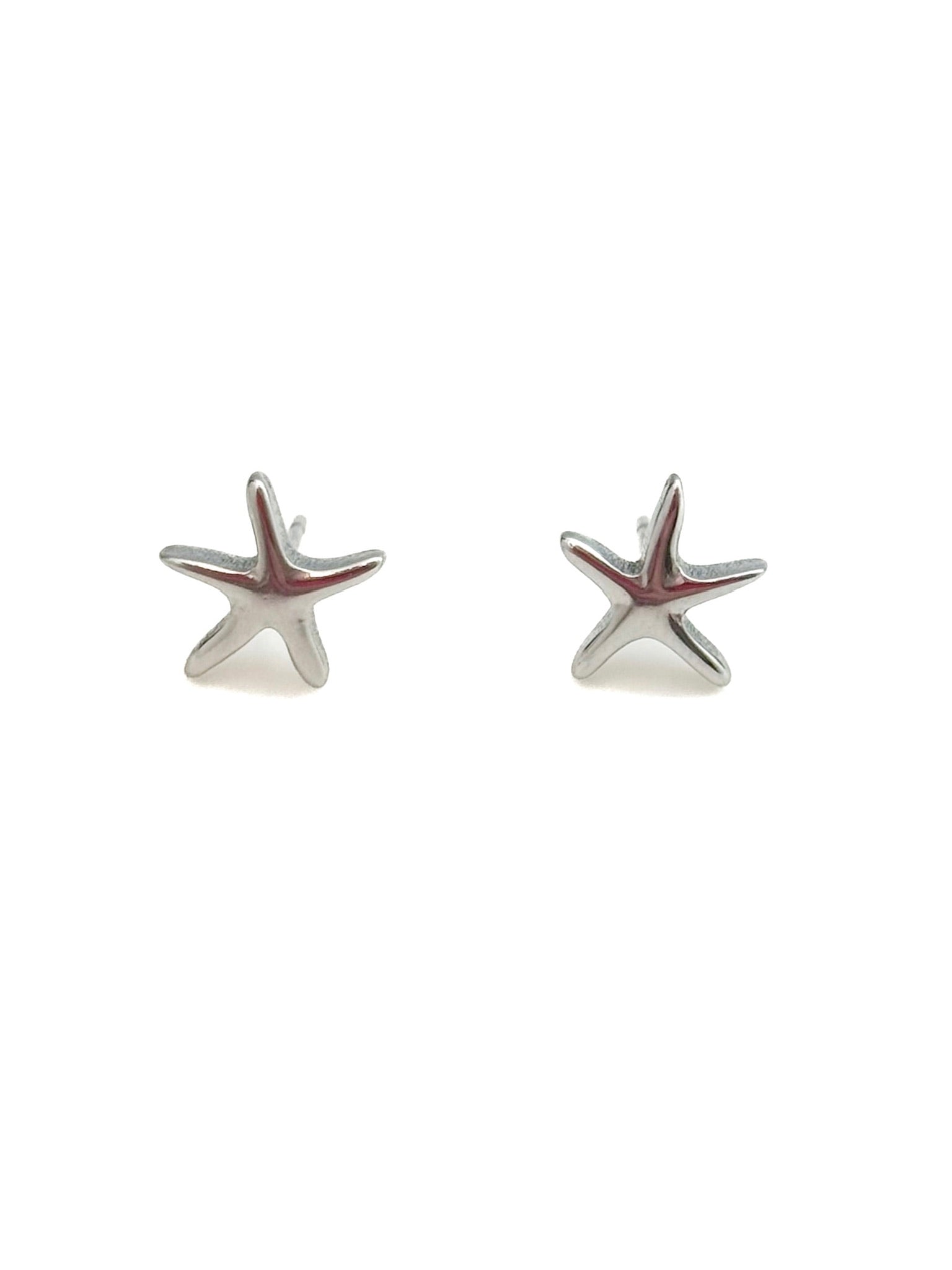 Starfish-shaped silver earrings on a white background
