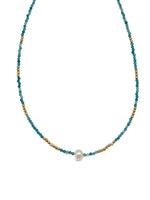 Sera Apatite Necklace with faceted blue apatite beads, gold accents, and a single center pearl on white background.
