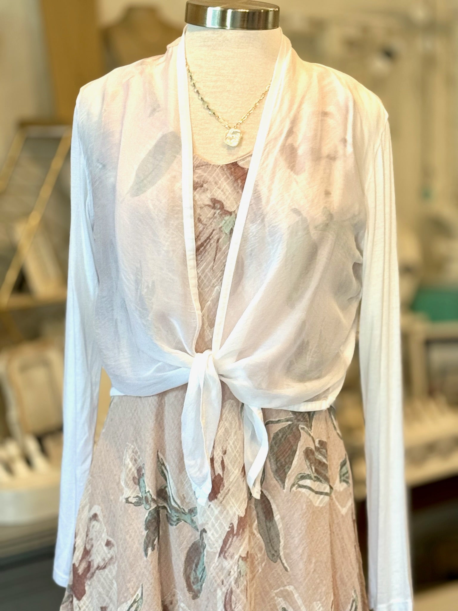 Dress shown with cardigan and necklace