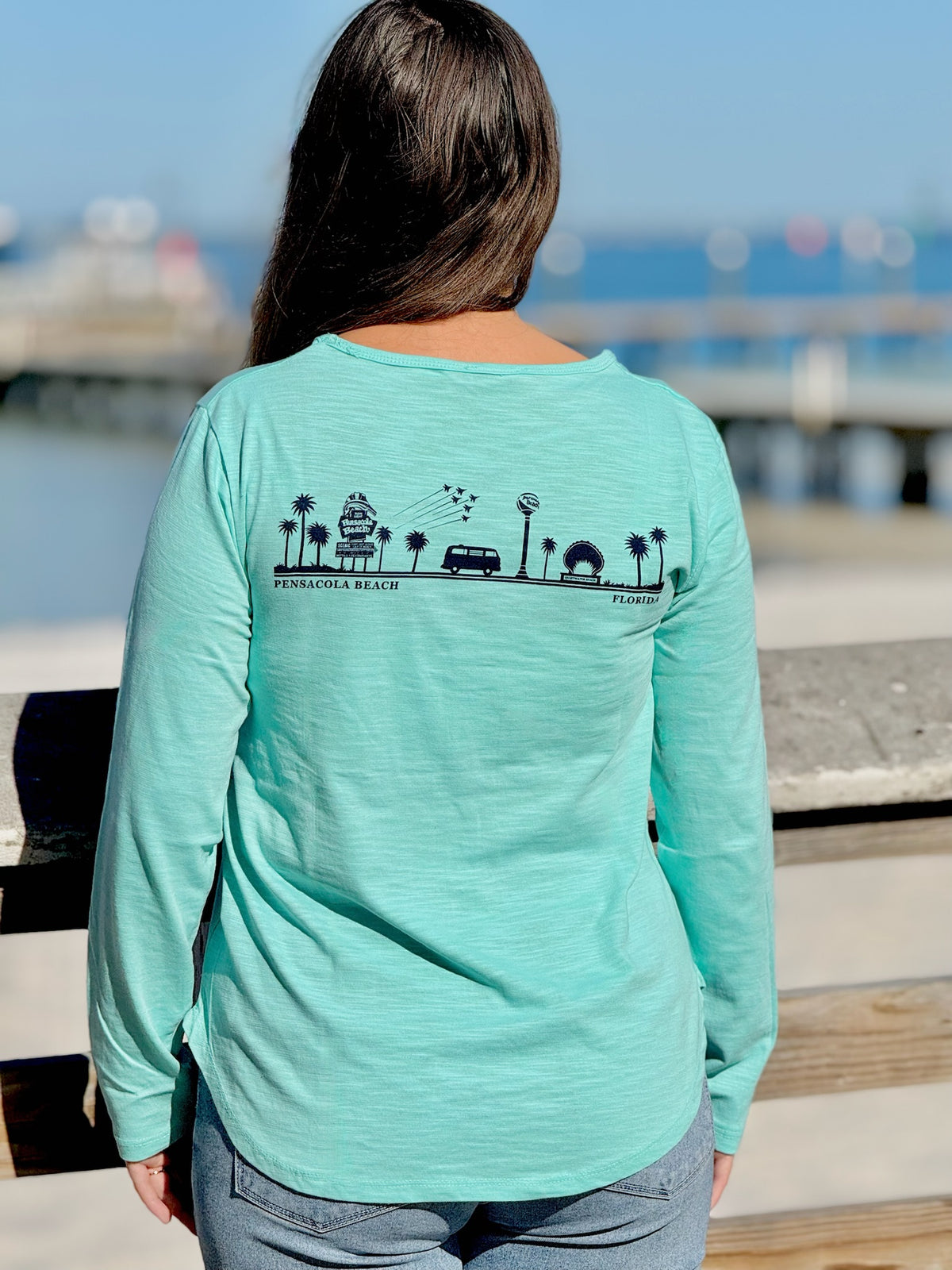 Person wearing an aqua women's Pensacola Beach long sleeve tee