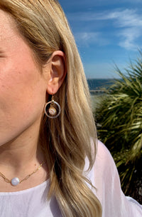 Angel pearl earrings mixed metals on model. 