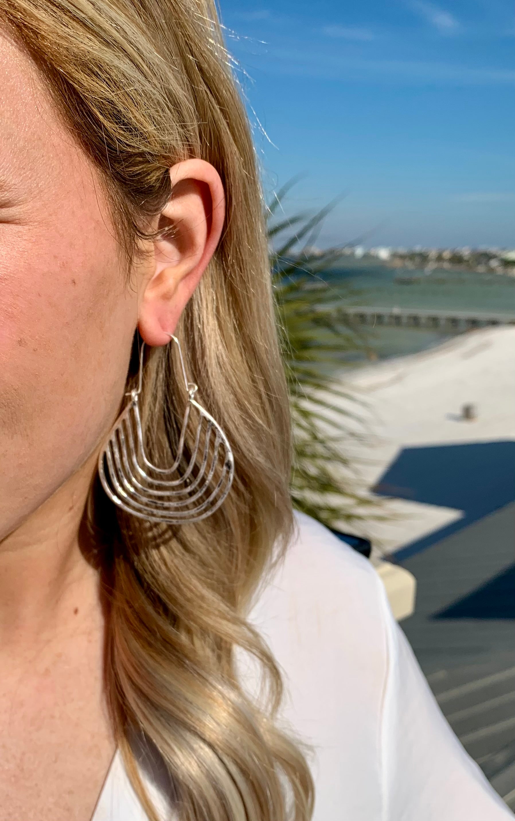 Mikayla silver drop hoop earrings on model for size reference