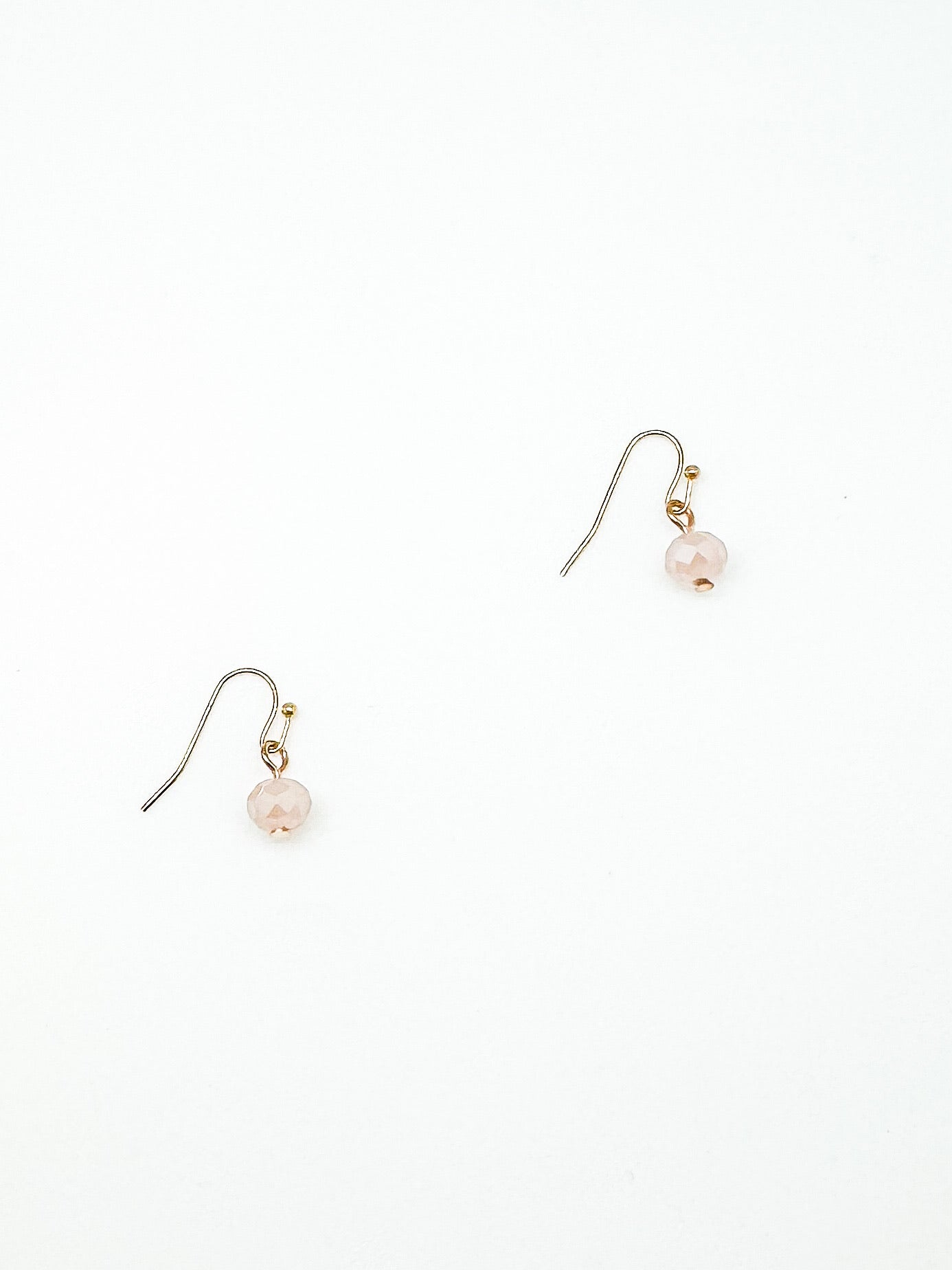 Pair earrings on a white background pink beaded 