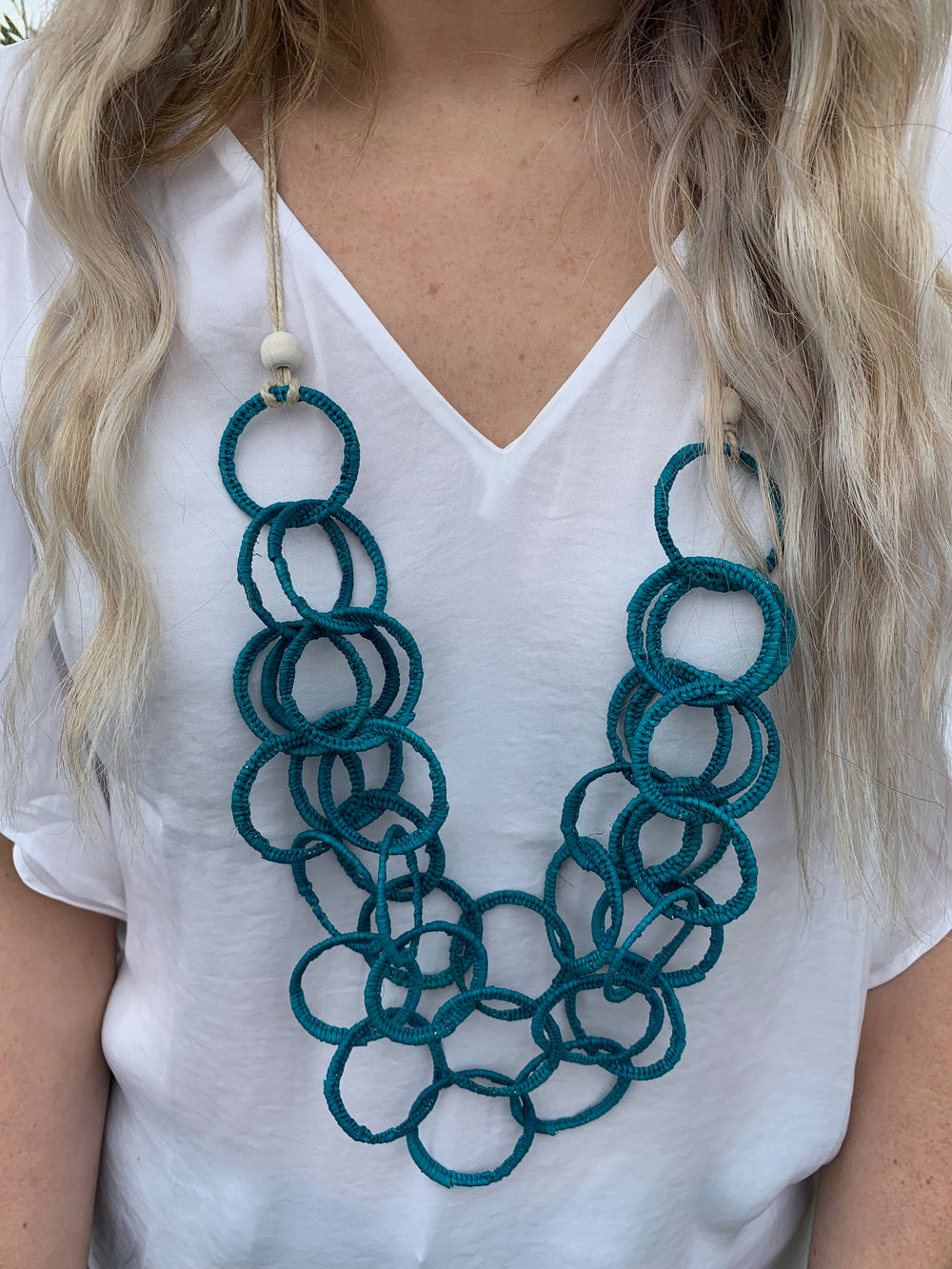 Model in Anita iraca plam necklace in teal 