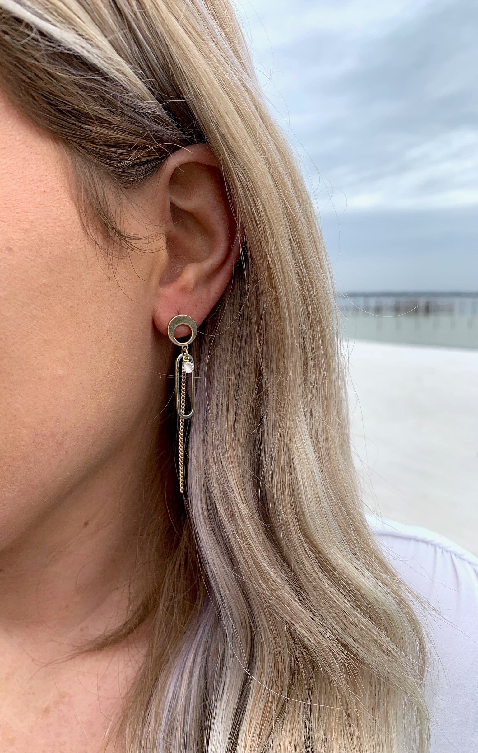Elianna abstract earrings gold on model.