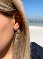 Kristy sparkle earrings in gold on model. 