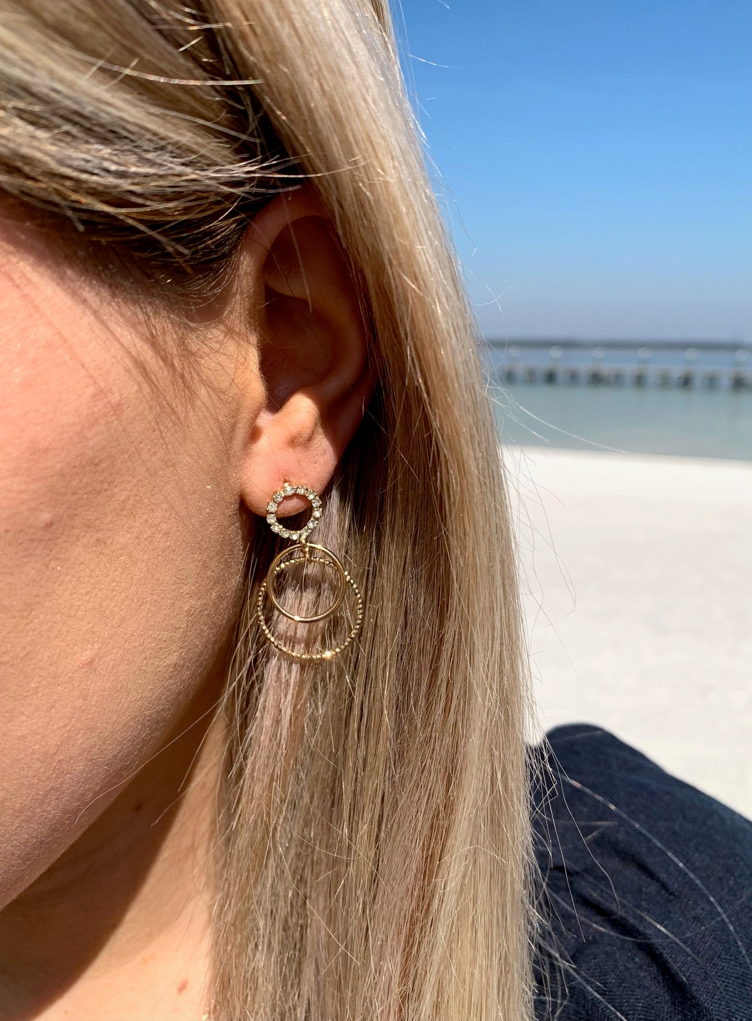 Kristy sparkle earrings in gold on model. 