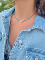 Model wearing Apatite Stainless Steel Necklace featuring sea-toned apatite beads with a freshwater pearl center detail.