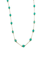 Turquoise beaded necklace on a white background