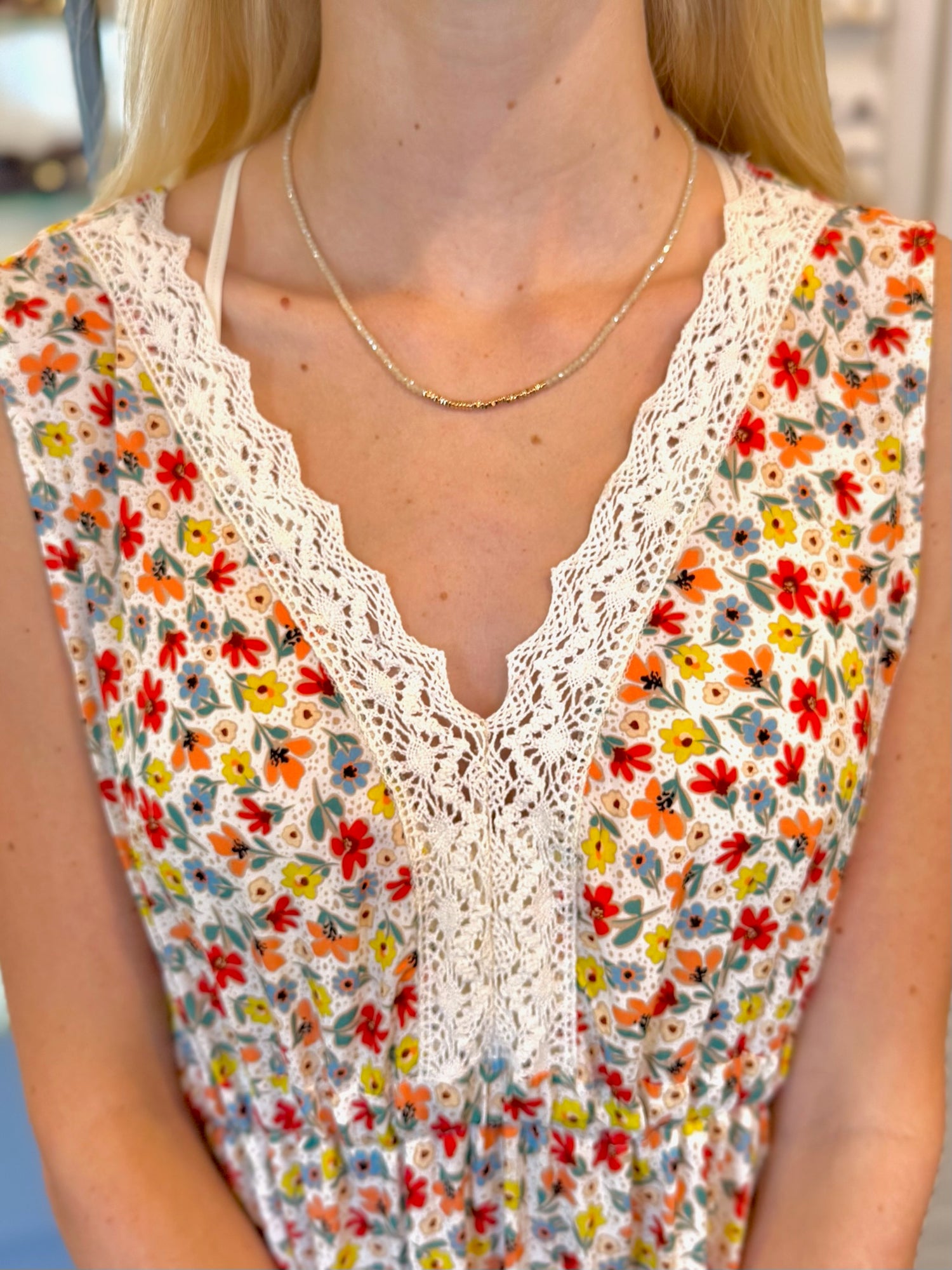 Eva Beaded Necklace with neutral beads and gold-tone accents on model neck 