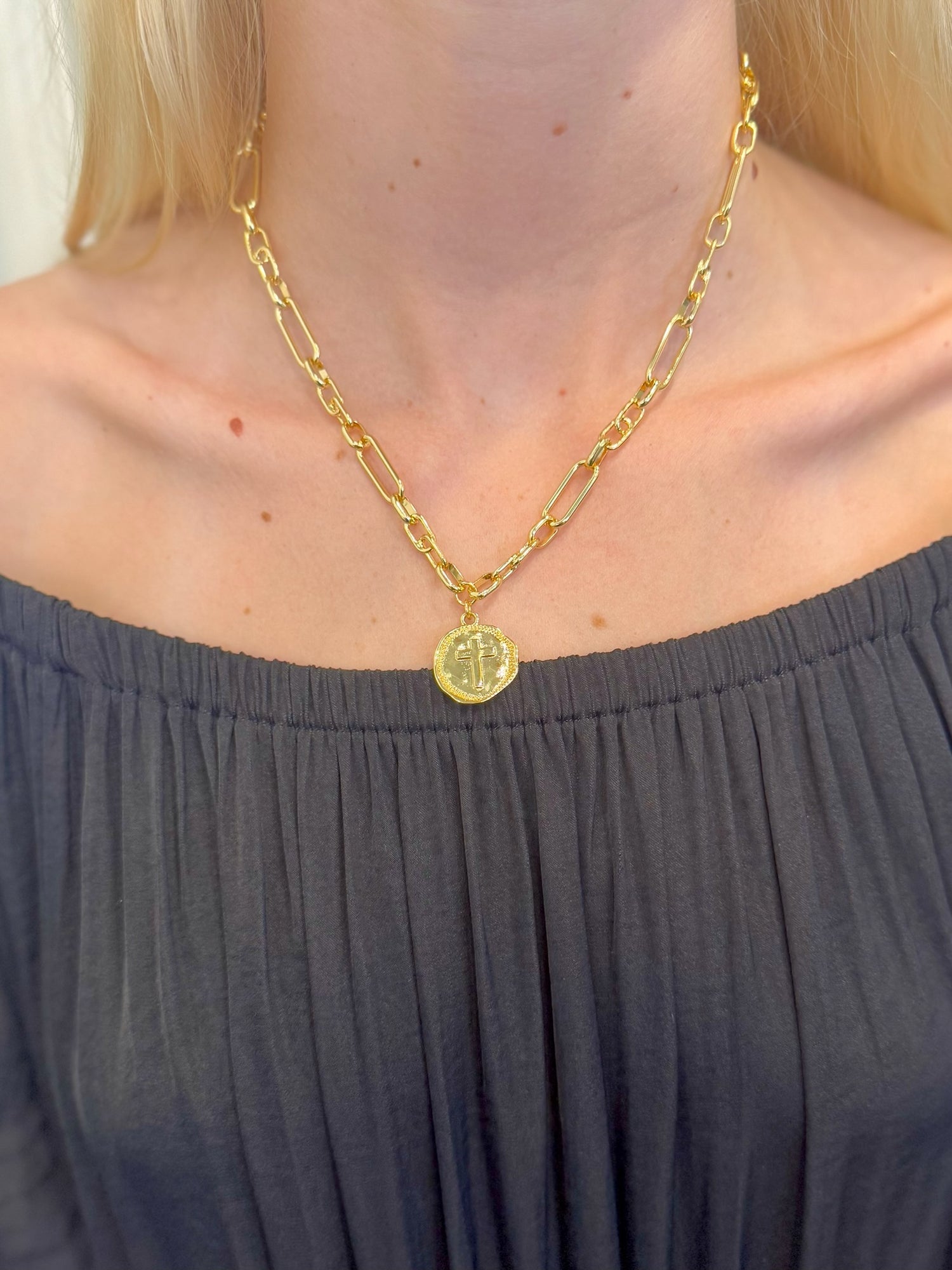 Sophia Gold  Medallion Cross Necklace with gold link chain on woman's neck 