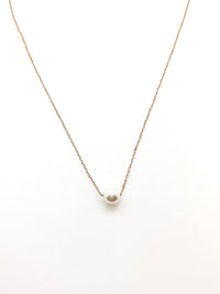simple gold chain necklace with a pearl in the center
