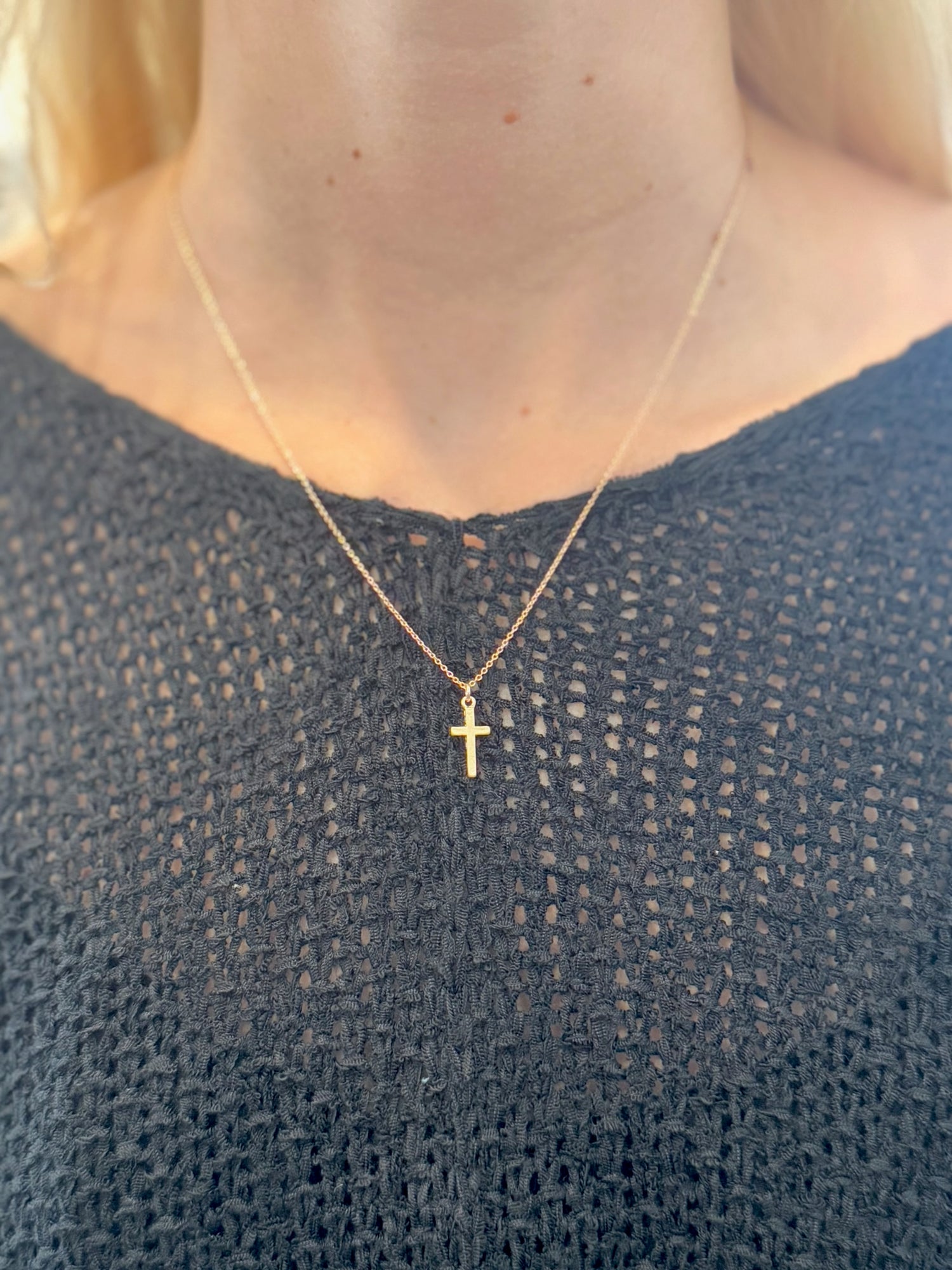 Juliette Cross Necklace in gold on delicate chain on woman's neck 