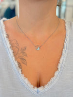 larimar wave sterling silver necklace worn with a V-neck top, showing length and placement.