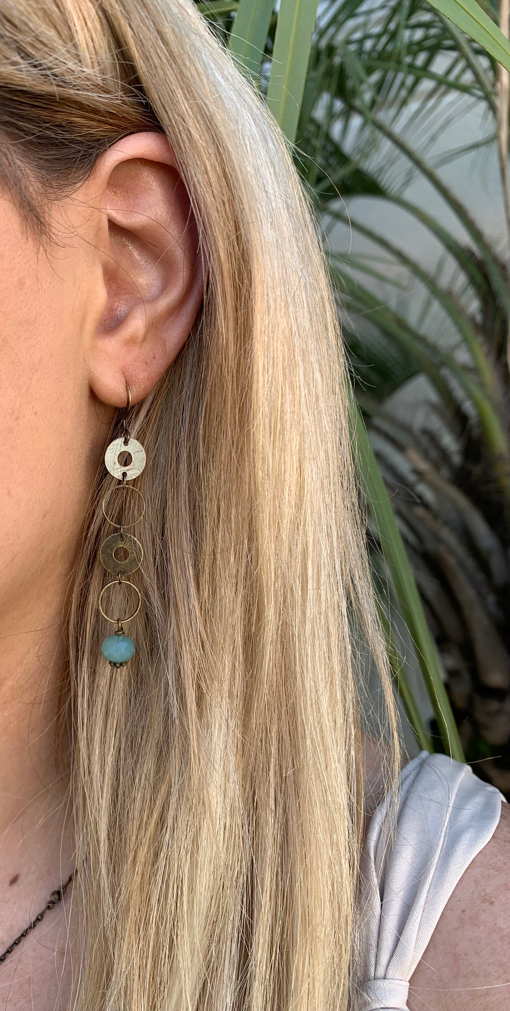 Long Brass earring Aqua on model.