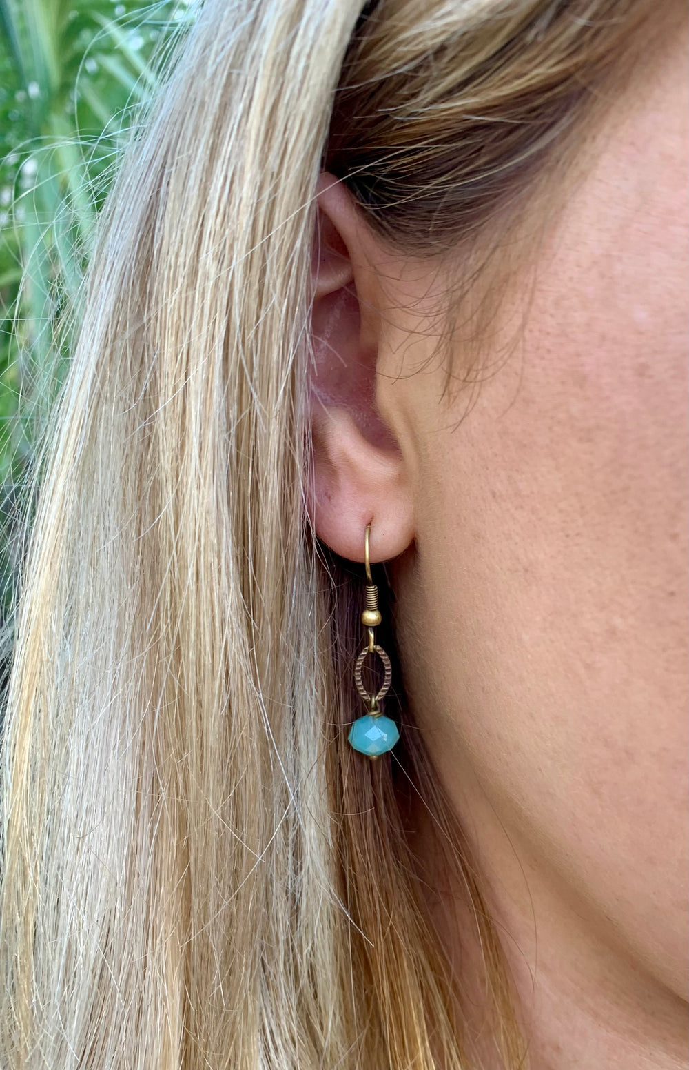 simple color drop earrings aqua with brass on model. 