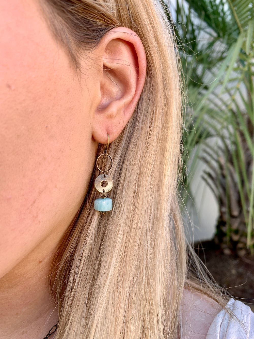 Amazonite mid length drop earrings in brass on model. 