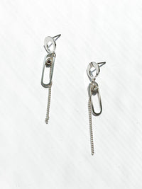 elianna abstract earring. circle at top then a paperclip shape with a chain and a crystal dangling in the center