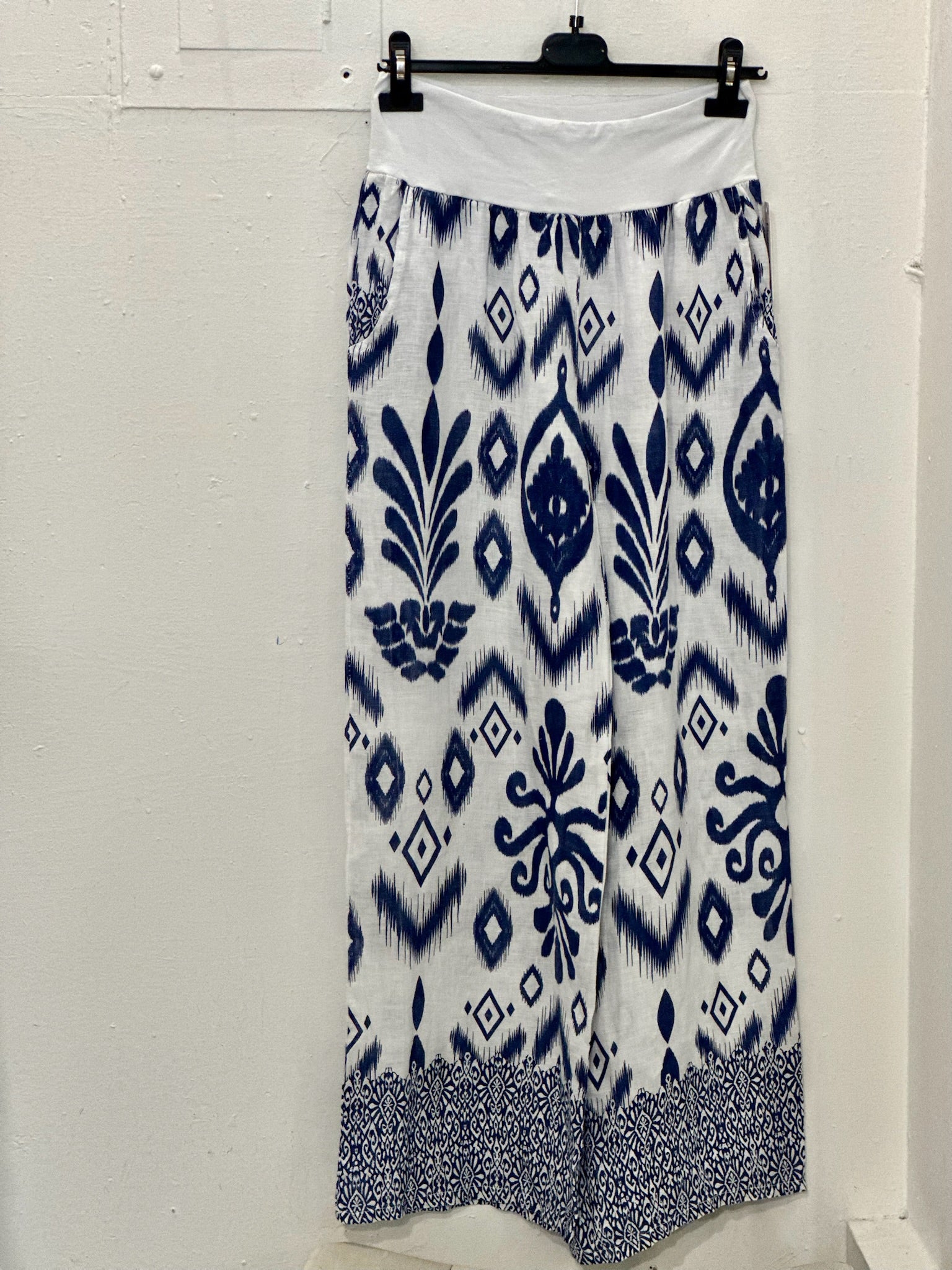 Brynn Italian linen wide-leg pants in navy and white geometric print with elastic pull-on waistband and border hem detail.