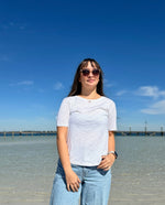 woman wearing a White t-shirt on the beach.