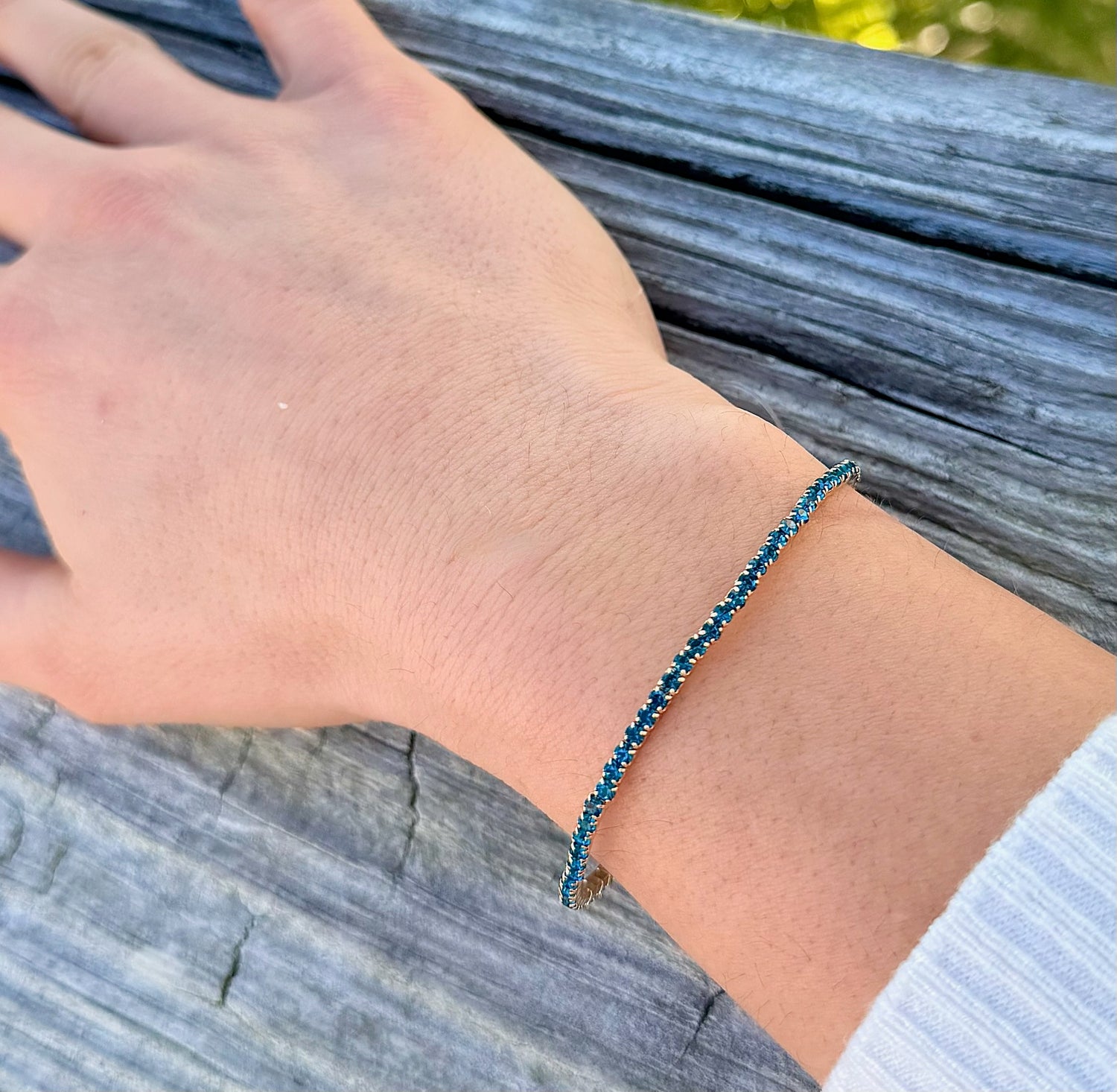 Marie Sparkly Bracelet in teal with gold-tone setting worn on wrist