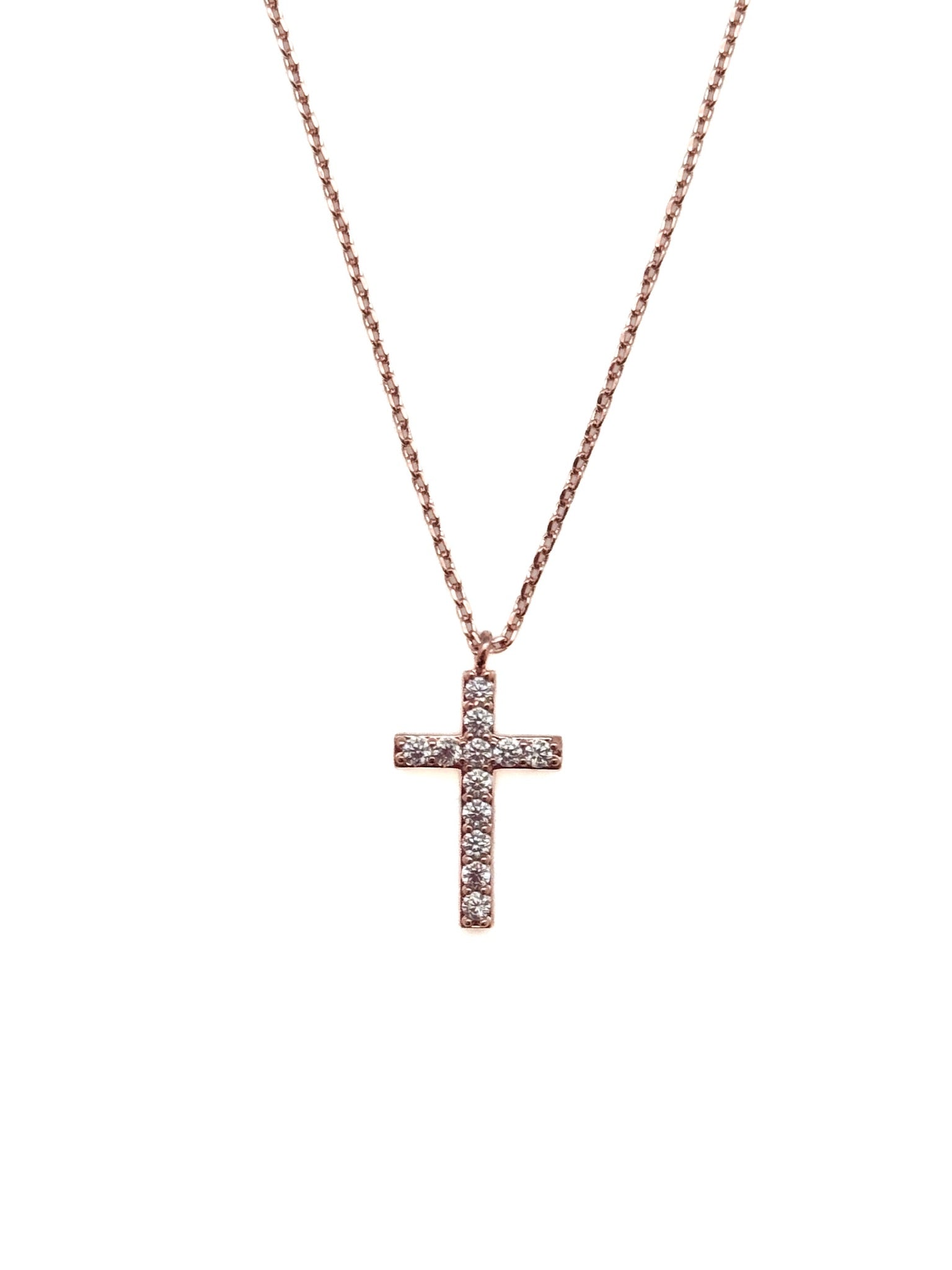 Rose gold cross necklace on a white background