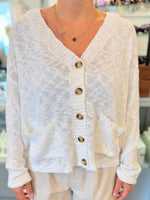 Back view of a lightweight white knit cardigan, slightly sheer with a relaxed fit. 
