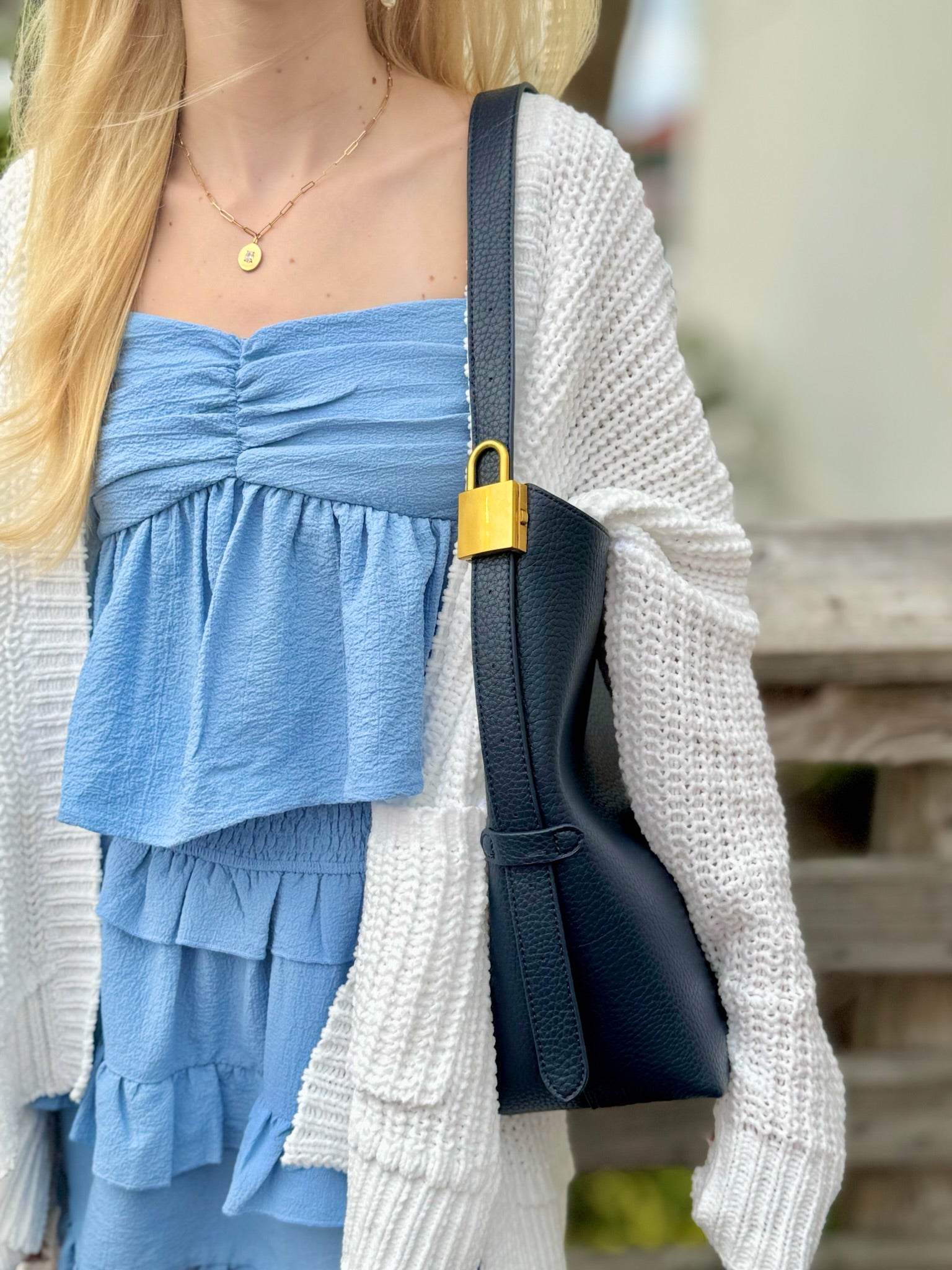Jade bag in navy being worn 
