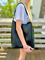 Jade bag in black being worn