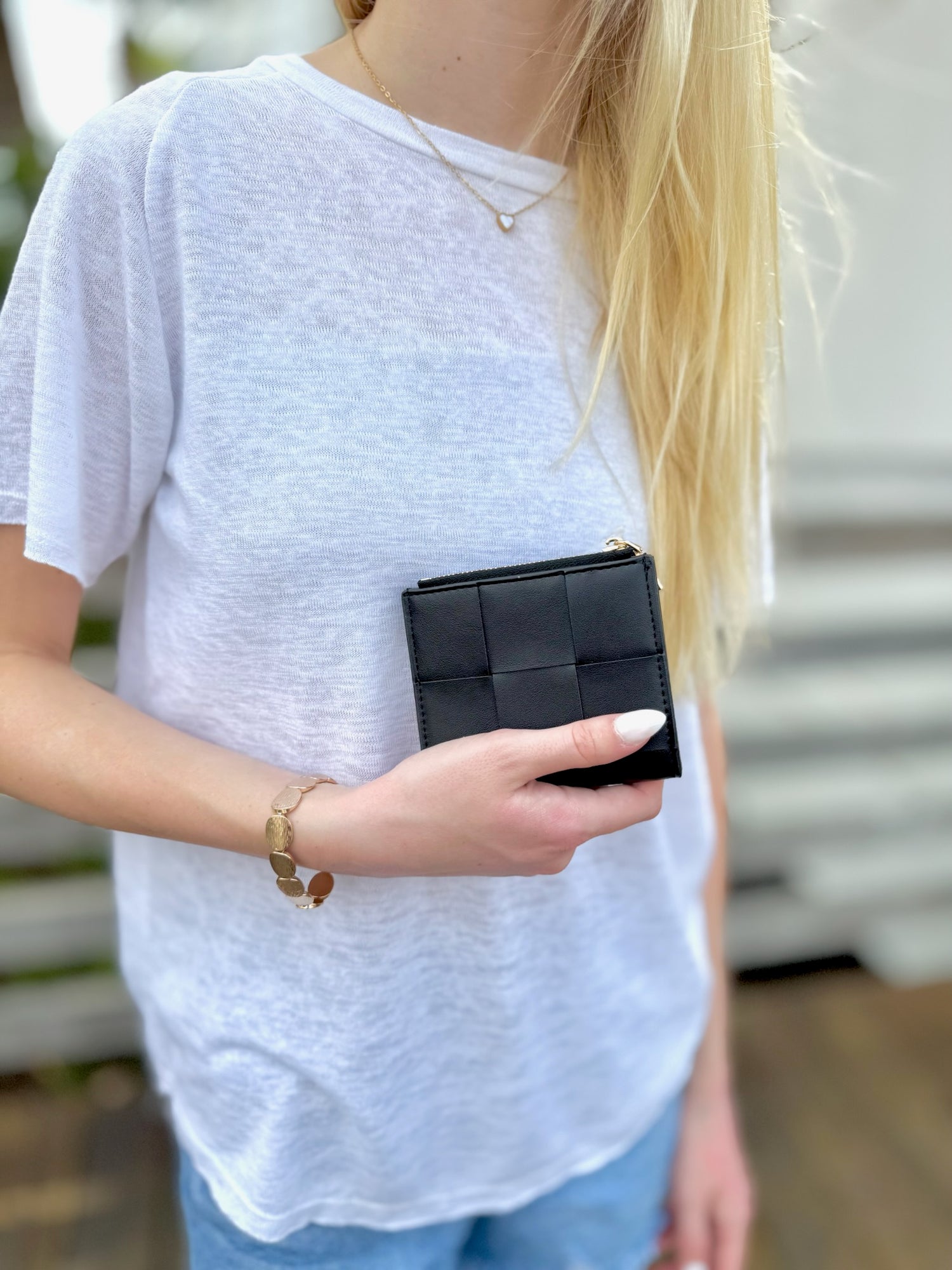 Person holding black wallet