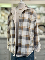 Plaid shirt on a mannequin with a blurred background