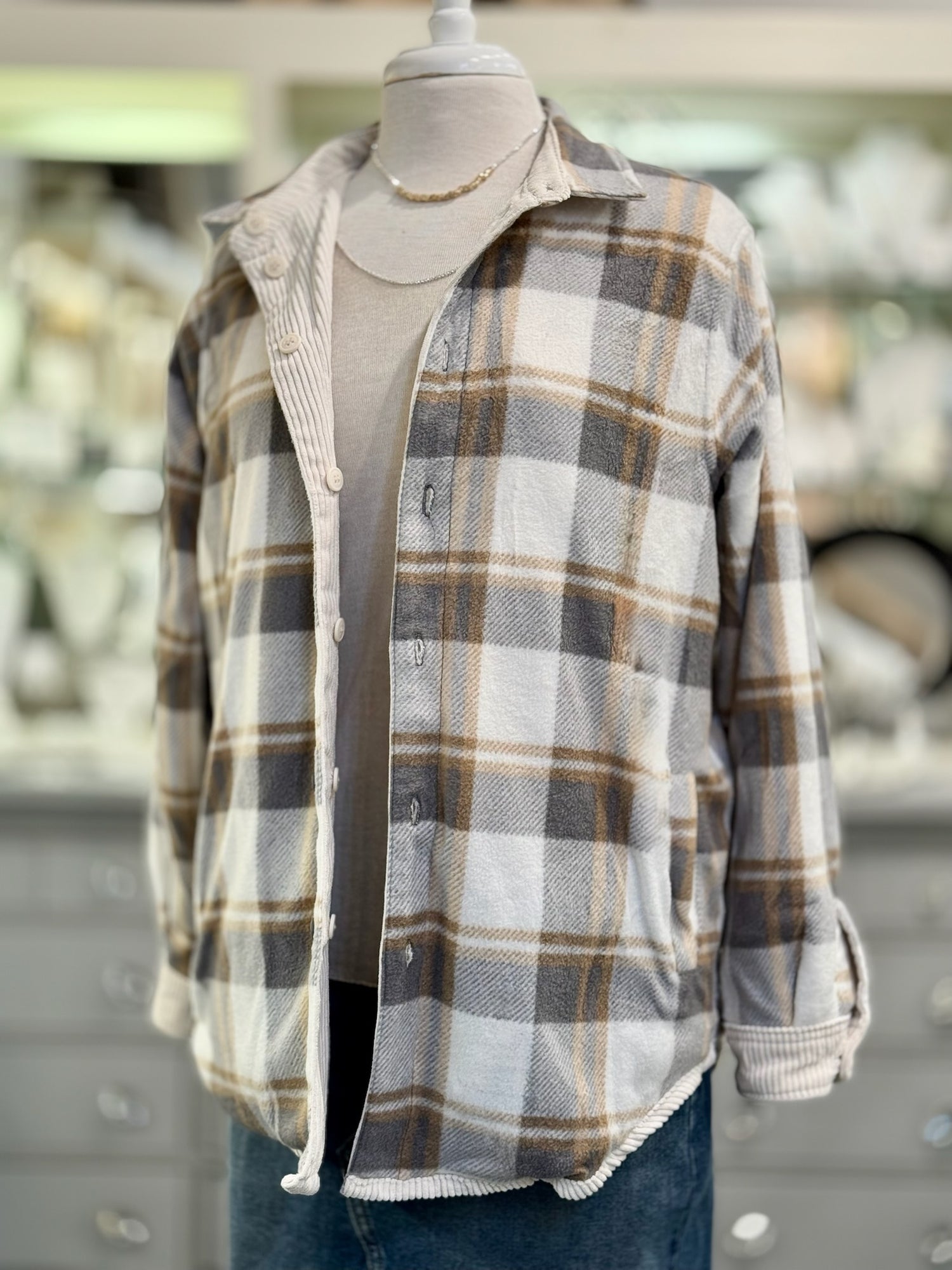 Plaid shirt on a mannequin with a blurred background