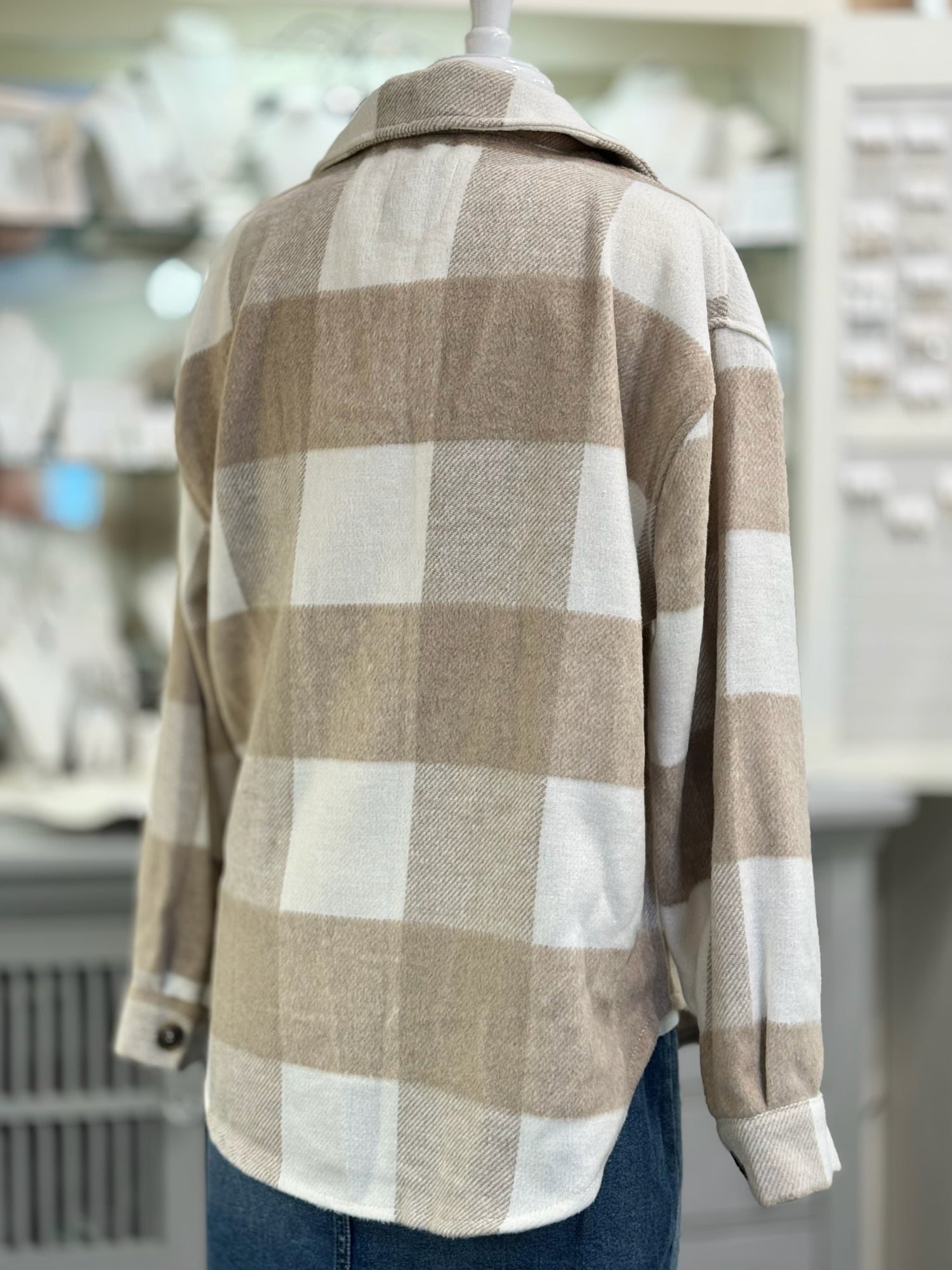 Plaid shirt on a mannequin in a store setting