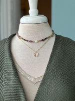 Jewelry shown layered as an outfit inso 