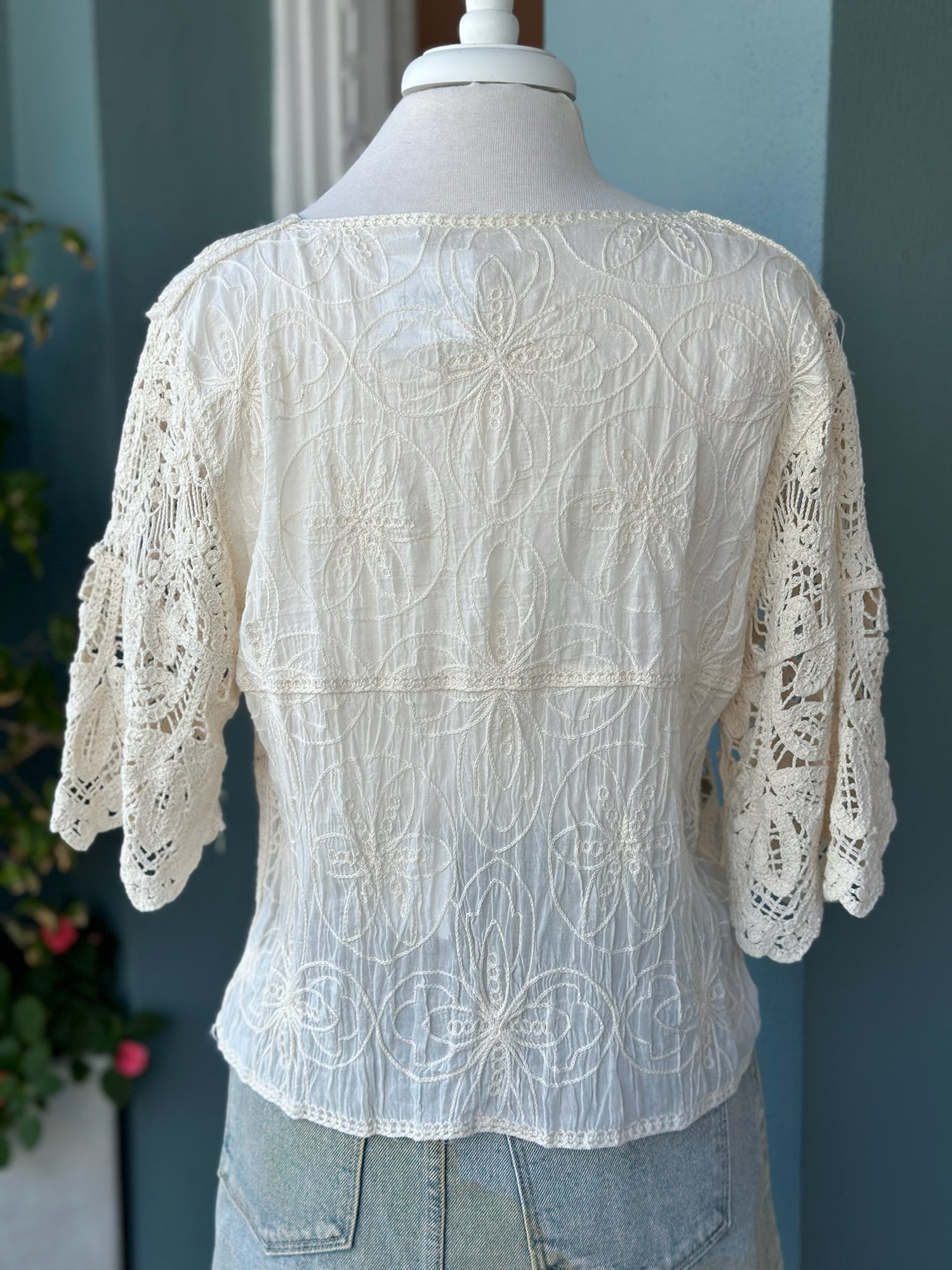 Back side view of beige lace front top 